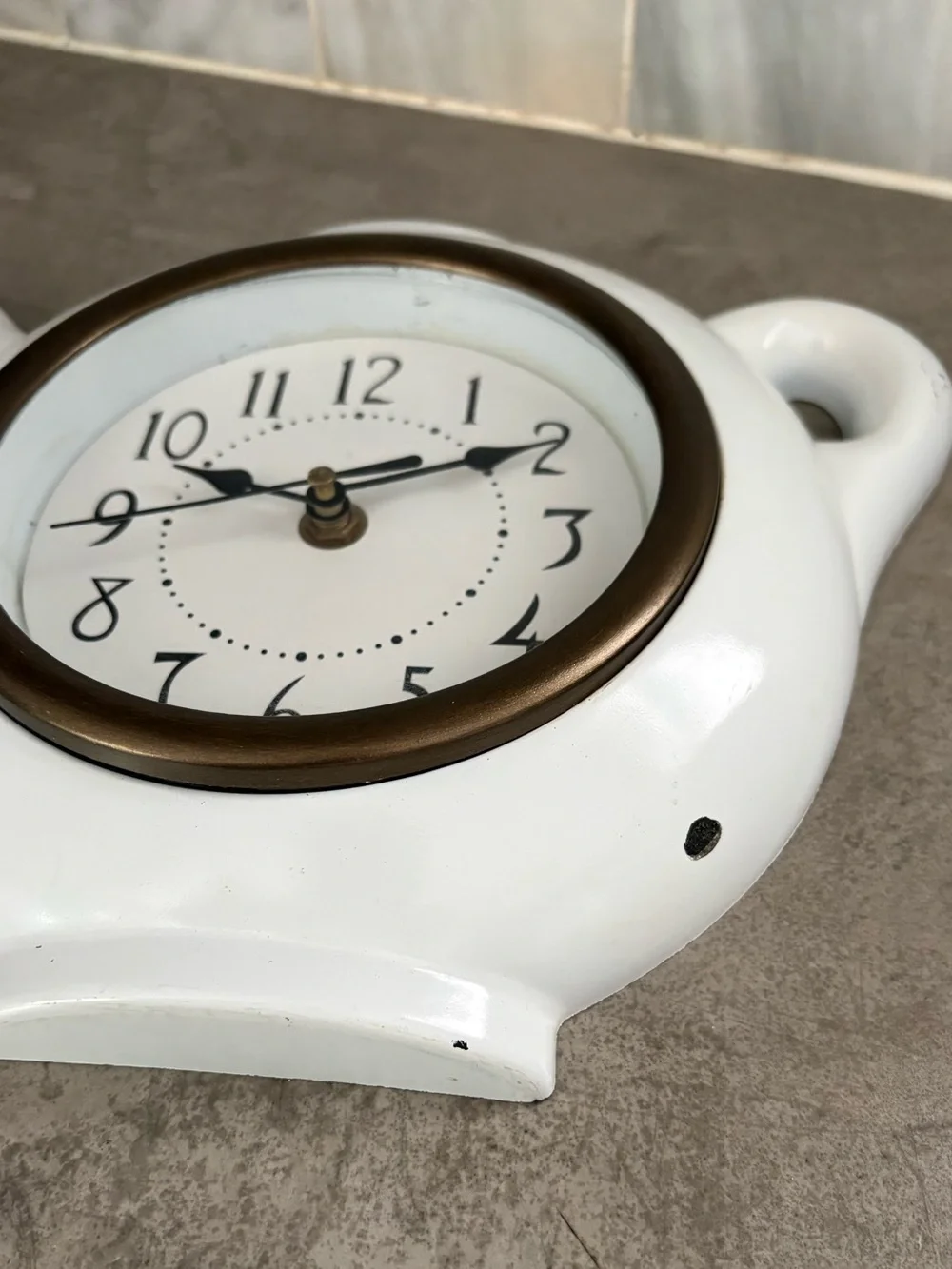 vintage teapot clock styled with a glossy white finish to look like ceramic.